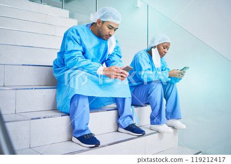Surgeon team, stairs and phone in hospital for telehealth, healthcare or online wellness. Smartphone, doctor and people on steps on internet, reading email and medical professional research in clinic Surgeon team, stairs and phone in hospital for telehealth, healthcare or online wellness. Smartphone, doctor and people on steps on internet, reading email and medical professional research in clinic 119212417