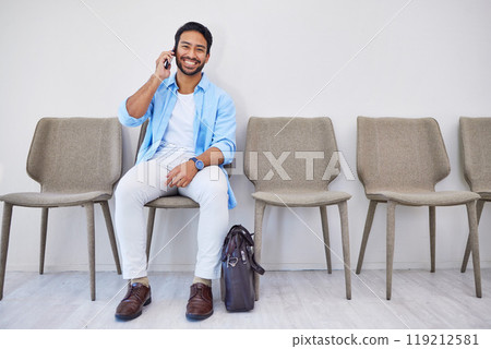 Recruitment, phone call and man in an office for interview in job search for appointment. Hiring, career and Indian male person on mobile conversation for meeting with human resources in workplace. 119212581