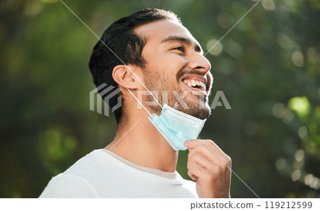 Smile, mask and remove with a man breathing fresh air in nature, feeling happy at the end of restrictions. Covid, freedom and post lockdown with a young person in the forest, woods or wilderness Smile, mask and remove with a man breathing fresh air in nature, feeling happy at the end of restrictions. Covid, freedom and post lockdown with a young person in the forest, woods or wilderness 119212599