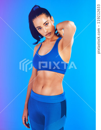 Shes always up for a challenge. Studio portrait of an attractive young sportswoman posing against a blue background. 119212633