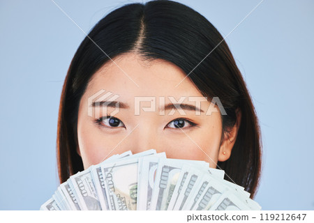 Money, beauty and woman cover face on blue background for winning, cash fan or financial prize. Lottery, portrait and asian person or winner with bonus, cosmetics secret or finance profit in studio Money, beauty and woman cover face on blue background for winning, cash fan or financial prize. Lottery, portrait and asian person or winner with bonus, cosmetics secret or finance profit in studio 119212647