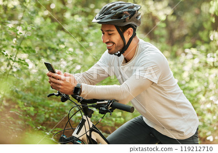 Man, forest and phone on bike, texting and smile for web chat notification on adventure in nature. Guy, cycling and smartphone for contact with bicycle, relax and social media app in woods on blog 119212710