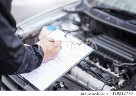 Checklist, car insurance and man writing on documents for compliance, maintenance and engine control. Vehicle, inspection and hand of male mechanic with paper form for information, note and claim 119212770