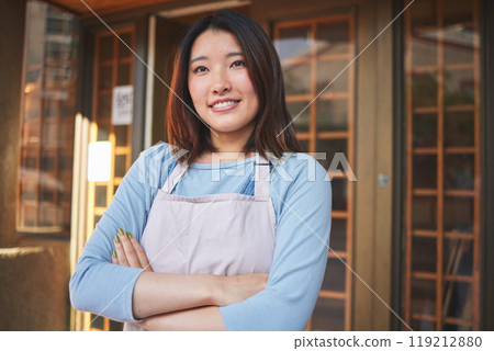 Happy, waitress and Asian woman with arms crossed at restaurant, coffee shop or startup store. Idea, smile and confident barista, thinking employee or small business entrepreneur at cafe in Japan 119212880