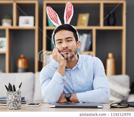 Tired, bunny ears and business man for Easter in office with decoration for celebration, event and party. Burnout, stress and Asian male person with fatigue at desk with rabbit headband for holiday Tired, bunny ears and business man for Easter in office with decoration for celebration, event and party. Burnout, stress and Asian male person with fatigue at desk with rabbit headband for holiday 119212970