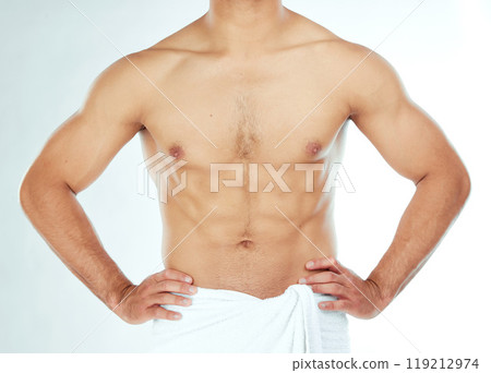 Body, closeup and fitness man in a towel in studio for shower, wellness or grooming on white background. Chest, stomach and male model relax in a bathroom for cosmetic, care or cleaning with sixpack Body, closeup and fitness man in a towel in studio for shower, wellness or grooming on white background. Chest, stomach and male model relax in a bathroom for cosmetic, care or cleaning with sixpack 119212974