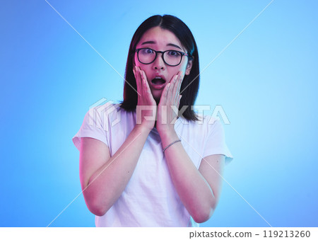 Surprise, open mouth and face of Asian woman with wow expression or shocked for drama, deal and promotion. Omg, wtf and portrait of person with discount emoji isolated in a studio blue background Surprise, open mouth and face of Asian woman with wow expression or shocked for drama, deal and promotion. Omg, wtf and portrait of person with discount emoji isolated in a studio blue background 119213260