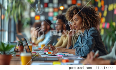 A diverse group of colleagues working on a group project. 119213278