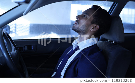 Car, sad and fired businessman from work, retrenched and unemployed in vehicle. Depression, lay off and stress corporate man person in parking lot, termination of contract and hopeless in transport 119213298