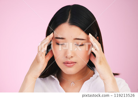 Asian woman, headache and stress in anxiety, tired or burnout against a pink studio background. Frustrated, upset or unhappy female person with migraine, injury or mental health pain on mockup space 119213526