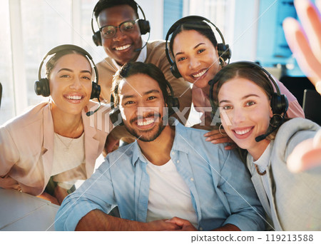 Selfie, call centre and people with headset in office for communication, customer service or telemarketing. Diverse group, man and woman with smile, happy and pose for teamwork, collaboration or bond 119213588