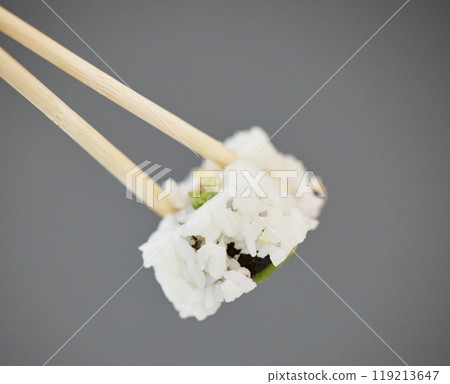 Seafood, sushi and chopsticks on studio background, California roll with seaweed for healthy Asian dining promo. Japanese food culture with rice, raw fish and avocado, restaurant menu offer or deal. Seafood, sushi and chopsticks on studio background, California roll with seaweed for healthy Asian dining promo. Japanese food culture with rice, raw fish and avocado, restaurant menu offer or deal. 119213647