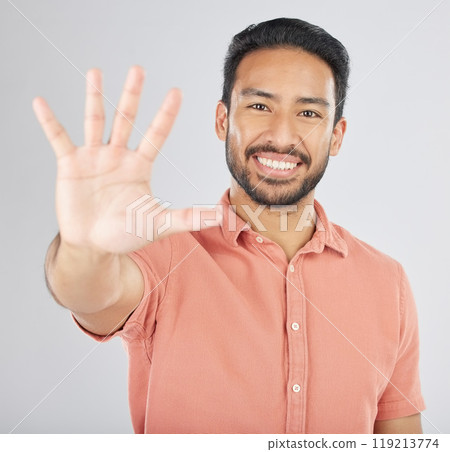 Smile, hand and portrait of man with stop gesture happy for communication isolated in a studio white background. Asian, sign language and confident young person with signal, symbol and hello sign 119213774