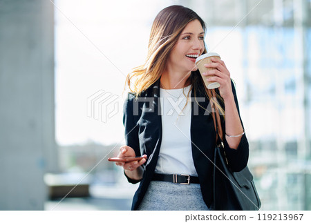 Start your morning with good ol caffeine. Cropped shot of an attractive young businesswoman drinking coffee while walking through a modern office. Start your morning with good ol caffeine. Cropped shot of an attractive young businesswoman drinking coffee while walking through a modern office. 119213967