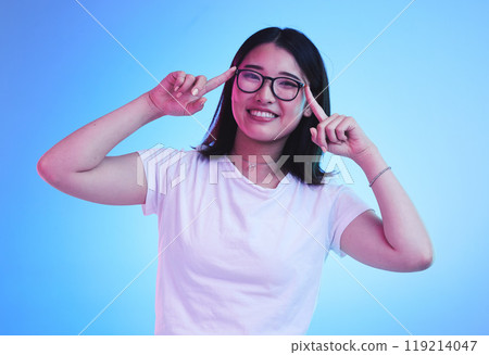 Portrait, thinking and Asian woman with glasses, ideas and opportunity on a blue studio background. Japanese person, face and model with eyewear, solution and decision with problem solving and choice 119214047