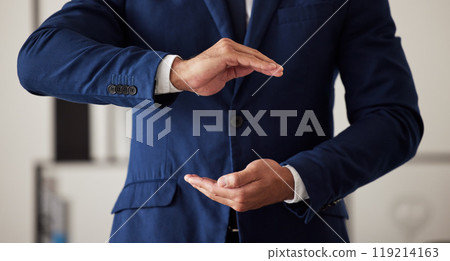 Hands, finance and a business man in the office closeup to offer cover for security or safety. Insurance, support and hand gesture with a male employee working in an investment agency for protection 119214163
