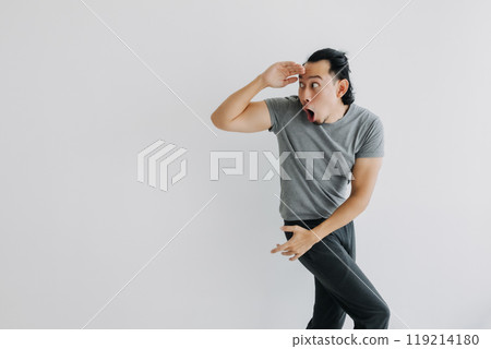 Unexpected surprise face man walking and turn on isolated background. Full body. 119214180