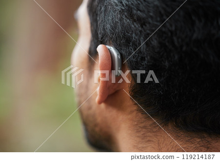 Closeup of hearing aid, ear and man with disability from the back for medical support, listening and healthcare tech. Deaf patient, face and audiology implant to help volume, vibration or sound waves Closeup of hearing aid, ear and man with disability from the back for medical support, listening and healthcare tech. Deaf patient, face and audiology implant to help volume, vibration or sound waves 119214187