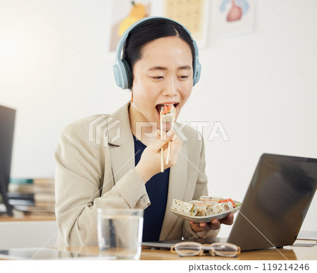 Fast food, delivery and asian woman with laptop in office for lunch break, eating and meal. Sushi, brunch and Japanese designer online with positive review, survey or feedback for takeout service 119214246