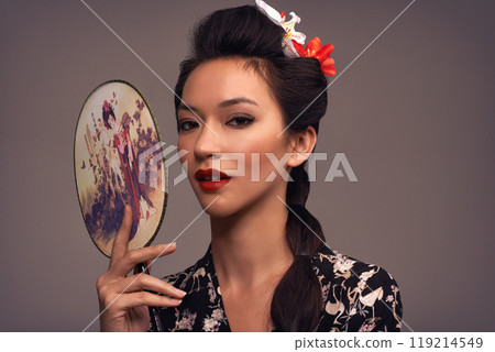 Face, Asian woman and beauty with hand mirror in studio on brown background in traditional style and elegant. Portrait, Japanese and female person with fashion, outfit and makeup for heritage Face, Asian woman and beauty with hand mirror in studio on brown background in traditional style and elegant. Portrait, Japanese and female person with fashion, outfit and makeup for heritage 119214549