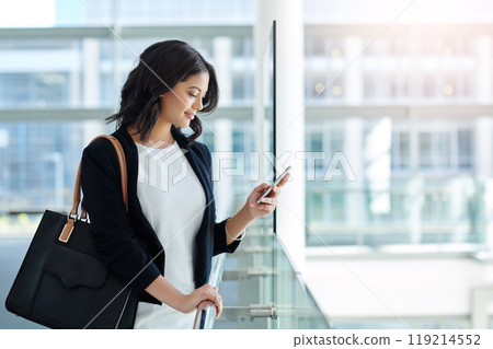 You can always count on her reply. Cropped shot of an attractive young businesswoman using a smartphone while standing in a modern office. You can always count on her reply. Cropped shot of an attractive young businesswoman using a smartphone while standing in a modern office. 119214552