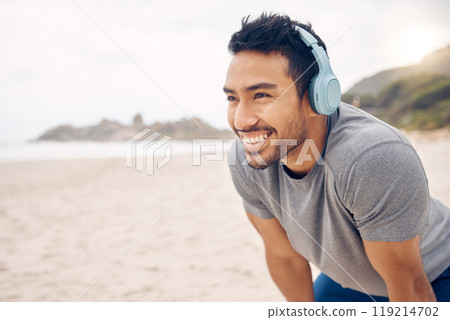 Break, beach and man workout to relax with a smile after cardio exercise. Fitness, jog and healthy athlete or male person rest in natural ocean with headphones for music and physical wellness Break, beach and man workout to relax with a smile after cardio exercise. Fitness, jog and healthy athlete or male person rest in natural ocean with headphones for music and physical wellness 119214702