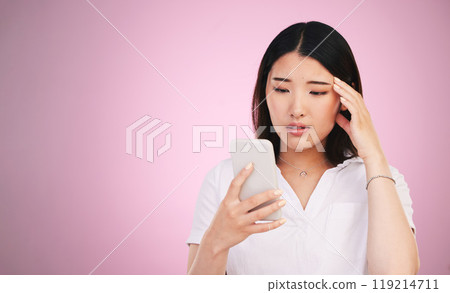 Space, phone and stress with face of woman in studio for networking, communication and worry. Social media, news and frustrated with asian person on pink background for technology, scam and mockup Space, phone and stress with face of woman in studio for networking, communication and worry. Social media, news and frustrated with asian person on pink background for technology, scam and mockup 119214711