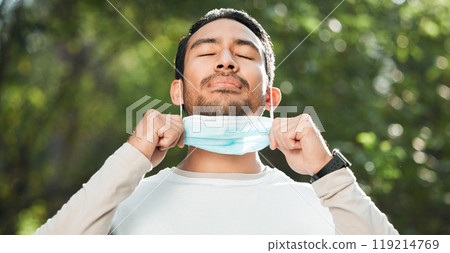 Covid, Asian man and take off mask for end of pandemic, breathing and outdoor protected. Corona, healthy guy and Japanese person remove face cover for fresh air, freedom and decrease infection rates 119214769