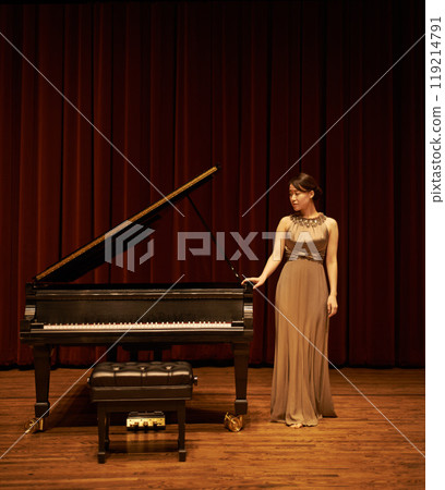 Piano, art theatre and Asian woman musician with concert music ready for performance with confidence. Thinking, curtain and musical with solo on stage in with pianist, instrument and fancy dress 119214791
