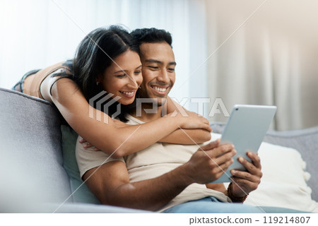 Happy, love and couple hug with tablet on sofa for social media, movies or streaming film at home. Support, smile or people in living room with digital, search or app for show, video or communication 119214807