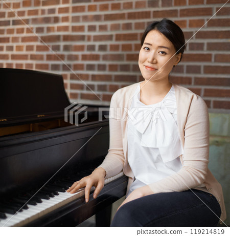 Piano, musician or portrait of woman in home for music training in an artistic classical performance. Teacher, relax and Asian female person playing a song, learning or practice routine in Japan Piano, musician or portrait of woman in home for music training in an artistic classical performance. Teacher, relax and Asian female person playing a song, learning or practice routine in Japan 119214819