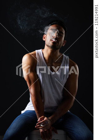 Smoking, sexy man and chair on black background in fitness inspiration, beauty aesthetic and sensual fashion. Erotic art, sexual body and male model with muscle, cigarette and studio in dark lighting Smoking, sexy man and chair on black background in fitness inspiration, beauty aesthetic and sensual fashion. Erotic art, sexual body and male model with muscle, cigarette and studio in dark lighting 119214991