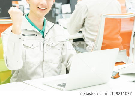 A faceless male engineer working in a sophisticated office 119215077