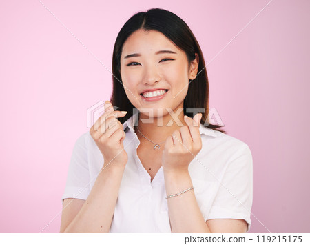 Happy asian woman, portrait and love hands, sign or gesture in romance against a pink studio background. Face of female person smile in happiness with loving emoji or symbol for valentines day Happy asian woman, portrait and love hands, sign or gesture in romance against a pink studio background. Face of female person smile in happiness with loving emoji or symbol for valentines day 119215175