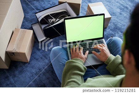 Ecommerce, man with laptop, green screen and boxes on floor, shoes and delivery service on digital app. Sale, discount and online shopping on fashion retail brand website, internet search on computer Ecommerce, man with laptop, green screen and boxes on floor, shoes and delivery service on digital app. Sale, discount and online shopping on fashion retail brand website, internet search on computer 119215281