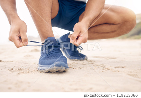 Running shoes, hands and fitness man at a beach for training, exercise or morning cardio zoom. Legs, closeup and male runner with sneakers lace outdoor for wellness, workout or marathon practice run Running shoes, hands and fitness man at a beach for training, exercise or morning cardio zoom. Legs, closeup and male runner with sneakers lace outdoor for wellness, workout or marathon practice run 119215360