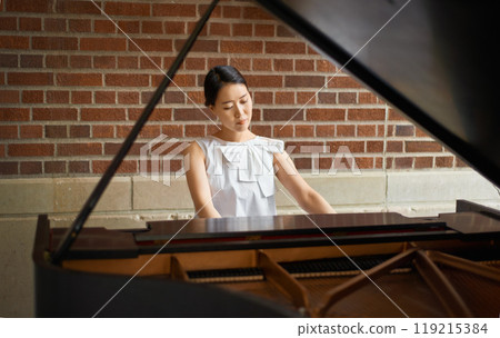 Piano, musician or Asian woman in a house for music training in an artistic classical performance. Creative lady, relax and female person playing a song, learning jazz or practice routine in Japan Piano, musician or Asian woman in a house for music training in an artistic classical performance. Creative lady, relax and female person playing a song, learning jazz or practice routine in Japan 119215384
