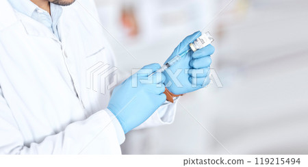 Hands, healthcare a vaccine with a doctor in the hospital closeup for treatment or cure using a syringe. Medical, needle and injection with a medicine professional in a clinic for pharmaceutical care Hands, healthcare a vaccine with a doctor in the hospital closeup for treatment or cure using a syringe. Medical, needle and injection with a medicine professional in a clinic for pharmaceutical care 119215494