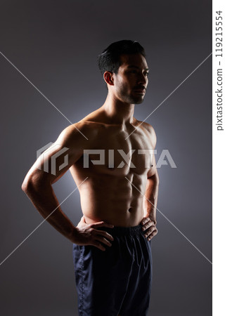 Muscle, body and studio man with fitness challenge results, bodybuilder progress and strong transformation training. Dark shadow, exercise and confident sports athlete thinking on grey background Muscle, body and studio man with fitness challenge results, bodybuilder progress and strong transformation training. Dark shadow, exercise and confident sports athlete thinking on grey background 119215554