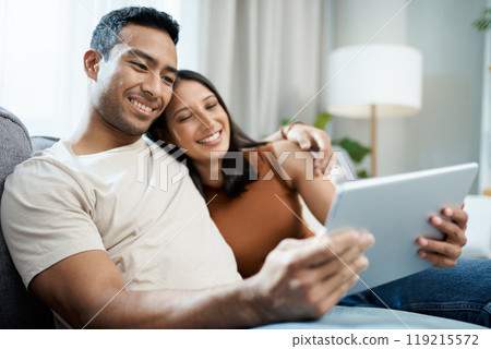 Happy couple, tablet and relax on sofa for online streaming, entertainment or social media at home. Man and woman sitting in living room with smile for technology, connection or networking at house 119215572