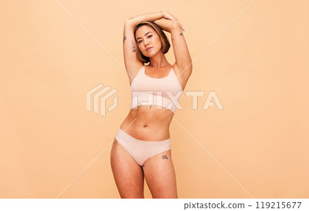 Portrait, underwear and body of woman in studio isolated on a brown background mockup space. Confidence, lingerie and Asian model in natural beauty, self love and positivity, health and wellness. 119215677