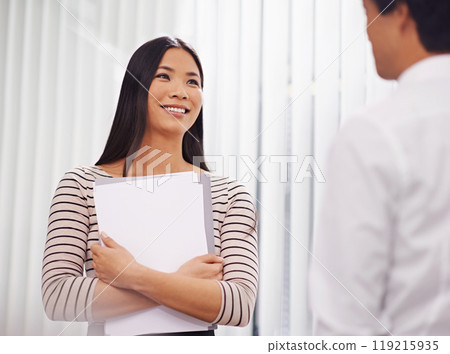 Documents, meeting and Asian business people in discussion, conversation and talking in office. Professional, creative agency and man and woman with project for planning, collaboration and teamwork 119215935