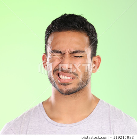 Migraine, man and pain with hurt from headache with stress and anxiety in a studio. Brain fog, tension and mistake with casual fashion and modern style with problem and issue with green background Migraine, man and pain with hurt from headache with stress and anxiety in a studio. Brain fog, tension and mistake with casual fashion and modern style with problem and issue with green background 119215988