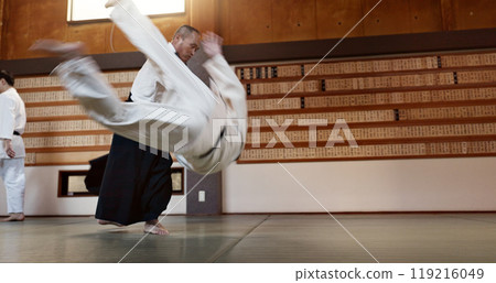 Japanese students, throw or sensei in dojo to start practice lesson, discipline or teaching self defense. Black belt master, people learning combat or athletes in fighting class, training or aikidoka 119216049