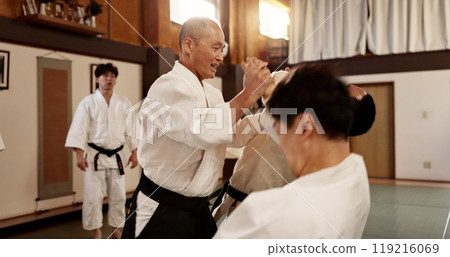 Aikido class, man and sensei for martial arts, learning and advice for combat at training, gym and dojo. Japanese people, master and sports with fight, workout and fitness for zen, conflict or club Aikido class, man and sensei for martial arts, learning and advice for combat at training, gym and dojo. Japanese people, master and sports with fight, workout and fitness for zen, conflict or club 119216069