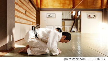 Japanese student, bow or men in dojo to start aikido practice, discipline or self defense education. Black belt master greeting, people learning respect or sensei ready in fighting class or training Japanese student, bow or men in dojo to start aikido practice, discipline or self defense education. Black belt master greeting, people learning respect or sensei ready in fighting class or training 119216117