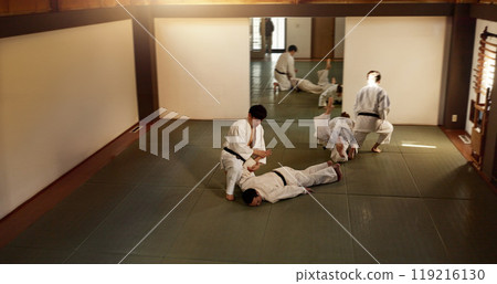 Japanese men, training and aikido fighting, modern martial arts and learning self defence. Respect, black belt students and instruction in dojo place and combat demonstration for discipline in class 119216130