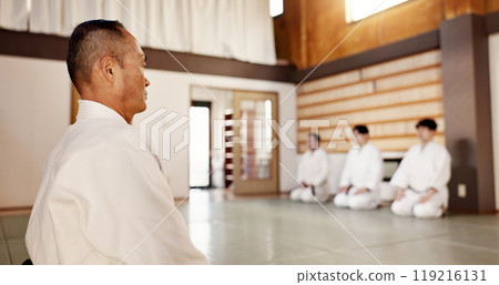 Japanese, men and aikido practice dojo or professional discipline, martial arts or black belt. Sensei, students and gee uniform in Tokyo for fight education as athlete or strong, fit or protection Japanese, men and aikido practice dojo or professional discipline, martial arts or black belt. Sensei, students and gee uniform in Tokyo for fight education as athlete or strong, fit or protection 119216131