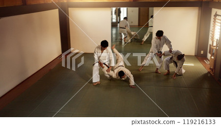 Japanese men, aikido class or training in fight, modern martial arts or learning self defence. Sensei, black belt students and instruction in dojo place, sport and combat demonstration for discipline 119216133