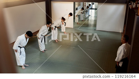 Japanese people, bow and learning aikido in dojo place in training and modern martial arts class of self defence. Group, black belt students and sensei with instruction and respect for discipline Japanese people, bow and learning aikido in dojo place in training and modern martial arts class of self defence. Group, black belt students and sensei with instruction and respect for discipline 119216164